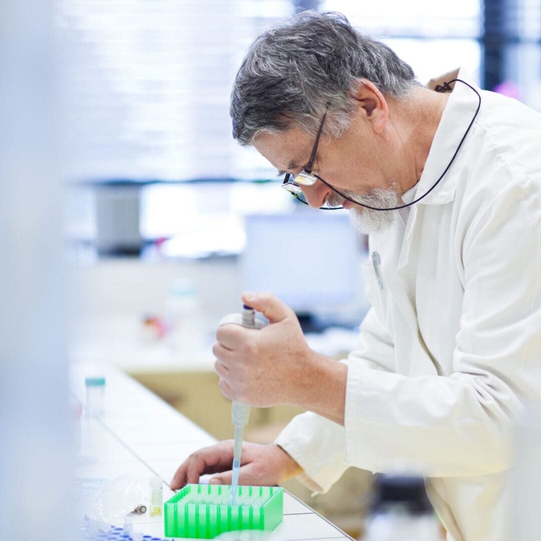 Scientist pipetting samples at laboratory bench